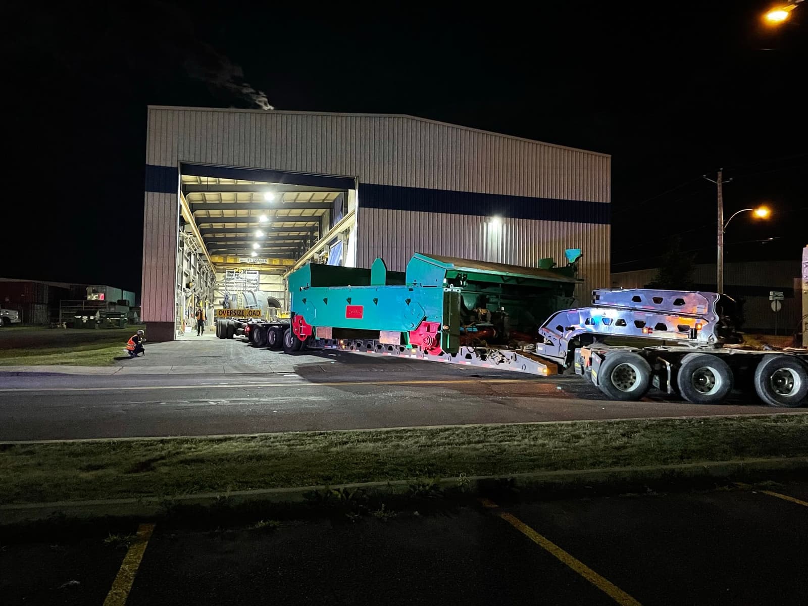 green cart being transported out of a fabrication shop